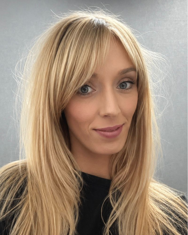 a portrait shot of a hair stylist with long blonde hair
